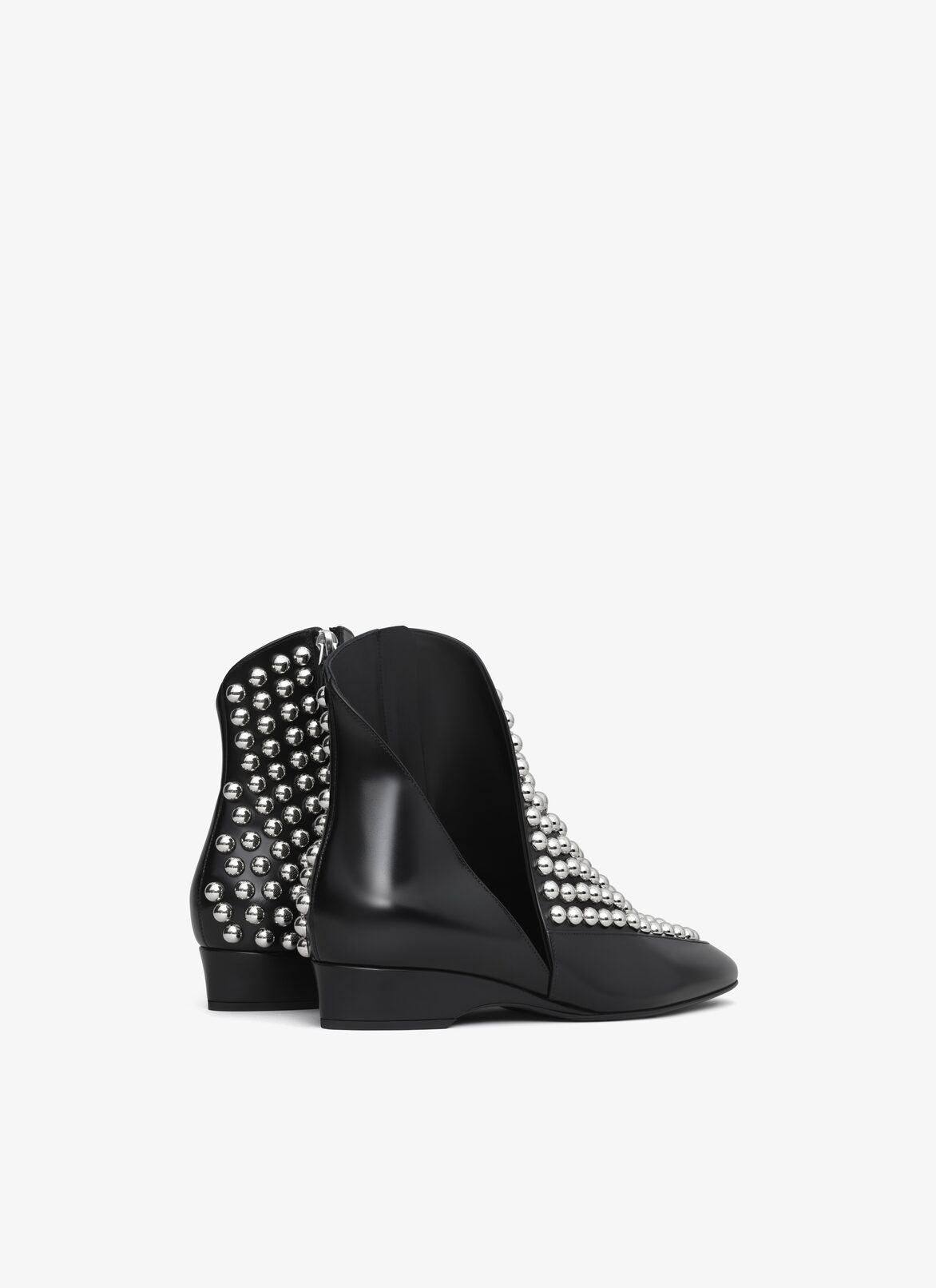 ASYMETRIC ANKLE BOOTS IN GLOSSY CALFSKIN WITH STUDS ALAÏA BLACK ASYMETRIC ANKLE BOOTS IN GLOSSY CALFSKIN WITH STUDS